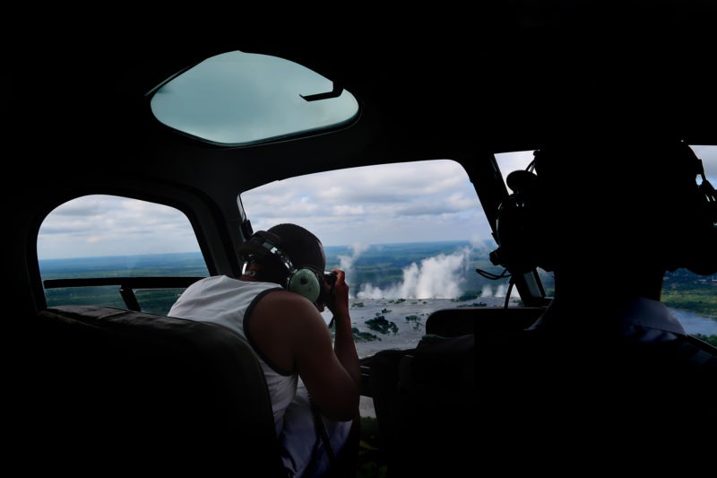 Wildlife photographer Clement Kiragu photographing the Zambias Victoria falls from a helicopter