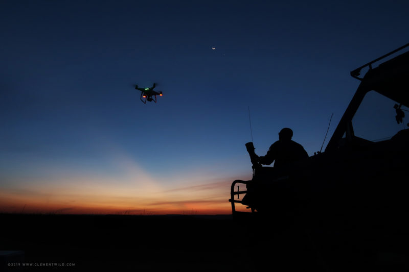 Silhouette of ClementWild at sunset with a drone and the new moon